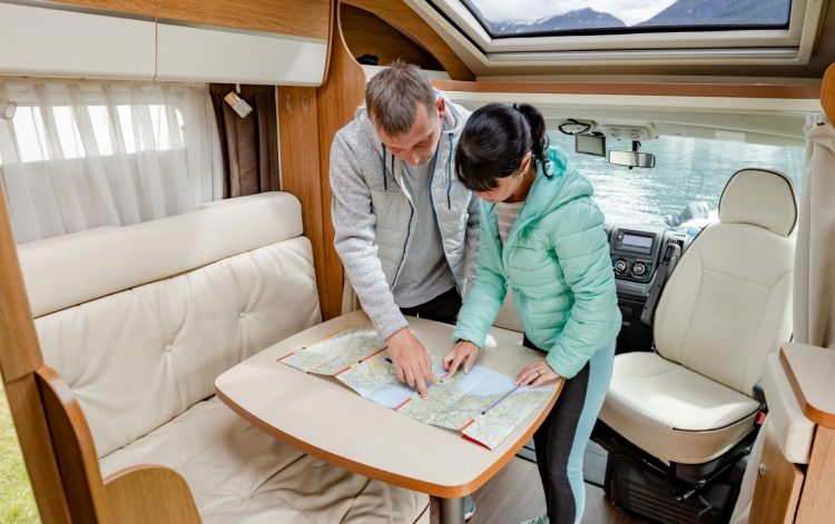 couples in rv camper looking at the local map for DUZ6CEP