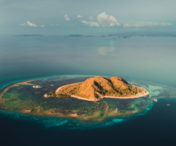 island among the ocean komodo aerial drone shot TB7W9SC